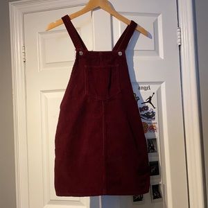 Burgundy overall dress from topshop .